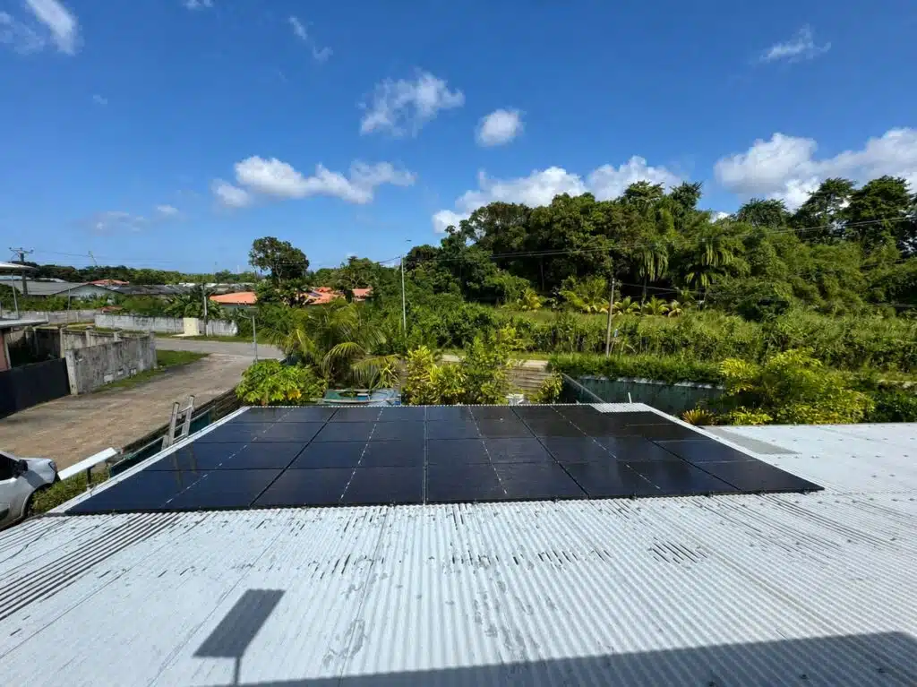 Panneaux solaires d'une installation de 9 kWc à Macouria (2026), vus depuis la toiture sous un ciel dégagé